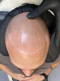 a man getting his hair shaved in a salon